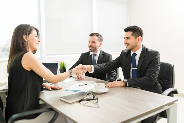 Career Transition - Image Career Transition confident female leader welcoming male employees with handshake office 662251 30