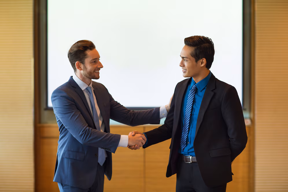 About Ontrac Coach smiling business leader greeting partner 1262 3306