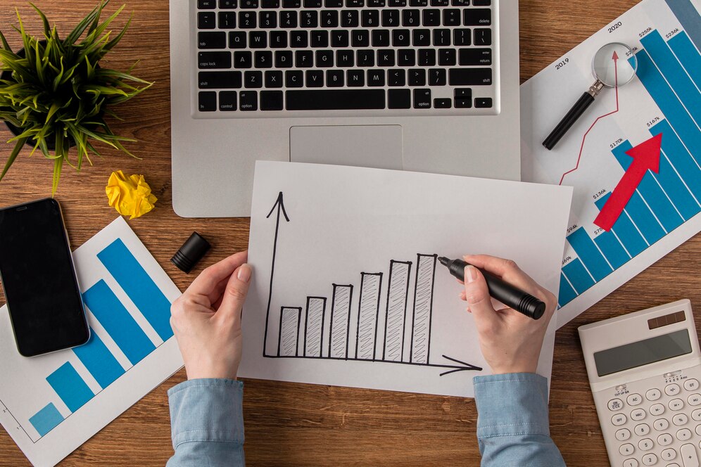 Practice Management top view office desk with calculator growth chart 23 2148780624